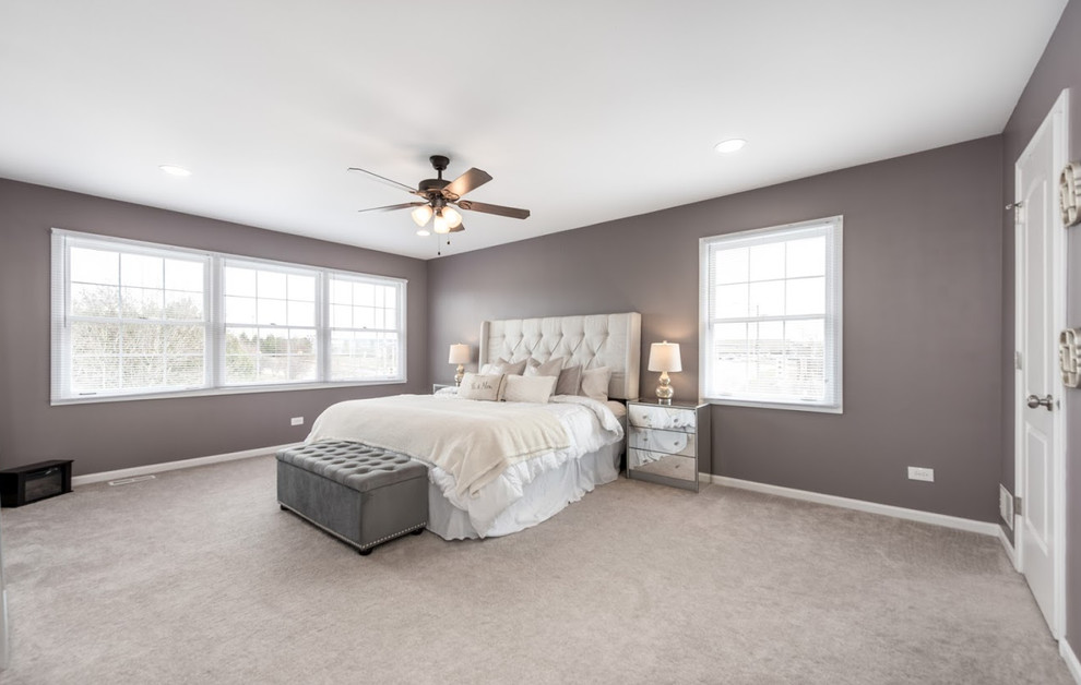This is an example of a large transitional master bedroom in Chicago with grey walls, carpet, no fireplace and grey floor.