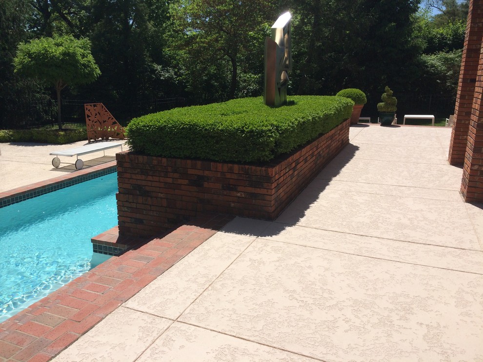 Photo of a mid-sized traditional backyard rectangular lap pool in St Louis with decking.