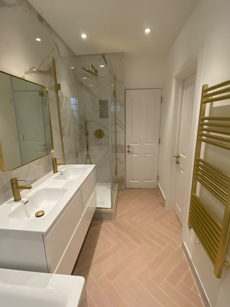 Design ideas for a large contemporary kids bathroom in London with flat-panel cabinets, white cabinets, a corner shower, a wall-mount toilet, porcelain tile, multi-coloured walls, porcelain floors, pink floor, a hinged shower door, a niche, a double vanity and a floating vanity.