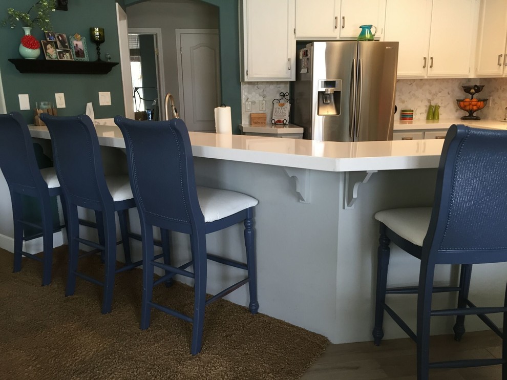 Porcelain tile eat-in kitchen photo with recessed-panel cabinets, gray cabinets, quartz countertops and white backsplash