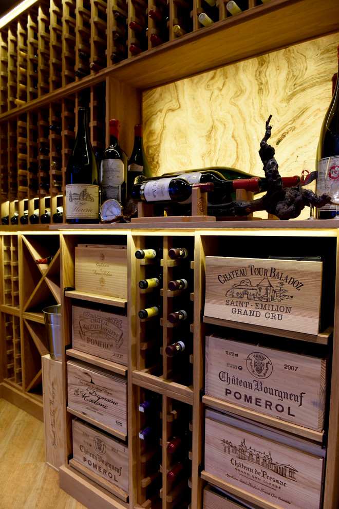 Design ideas for a large contemporary wine cellar in Other with storage racks, light hardwood floors and brown floor.