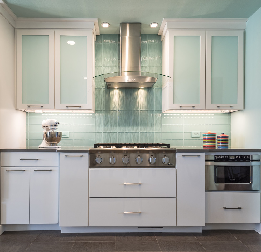 Inspiration for a large modern l-shaped eat-in kitchen in St Louis with an undermount sink, flat-panel cabinets, white cabinets, quartz benchtops, blue splashback, glass tile splashback, white appliances and no island.