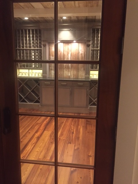 Mid-sized country wine cellar in Atlanta with medium hardwood floors, diamond bins and brown floor.