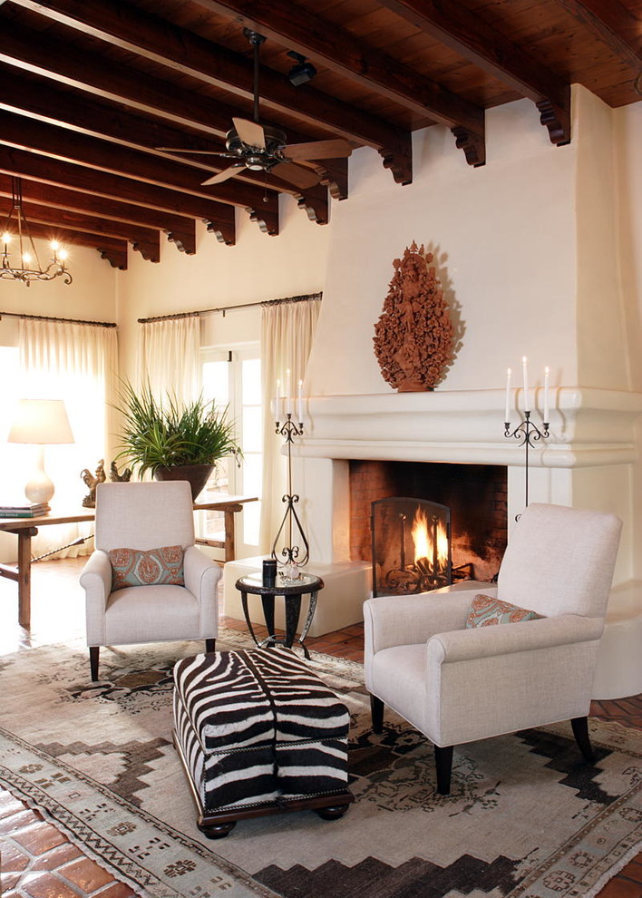 Photo of a large mediterranean formal open concept living room in San Diego with white walls, no tv, terra-cotta floors, a standard fireplace, a plaster fireplace surround and multi-coloured floor.