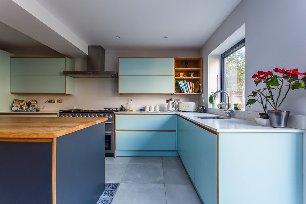 Design ideas for a mid-sized midcentury l-shaped eat-in kitchen in Sussex with a drop-in sink, flat-panel cabinets, blue cabinets, quartzite benchtops, stainless steel appliances, with island and white benchtop.