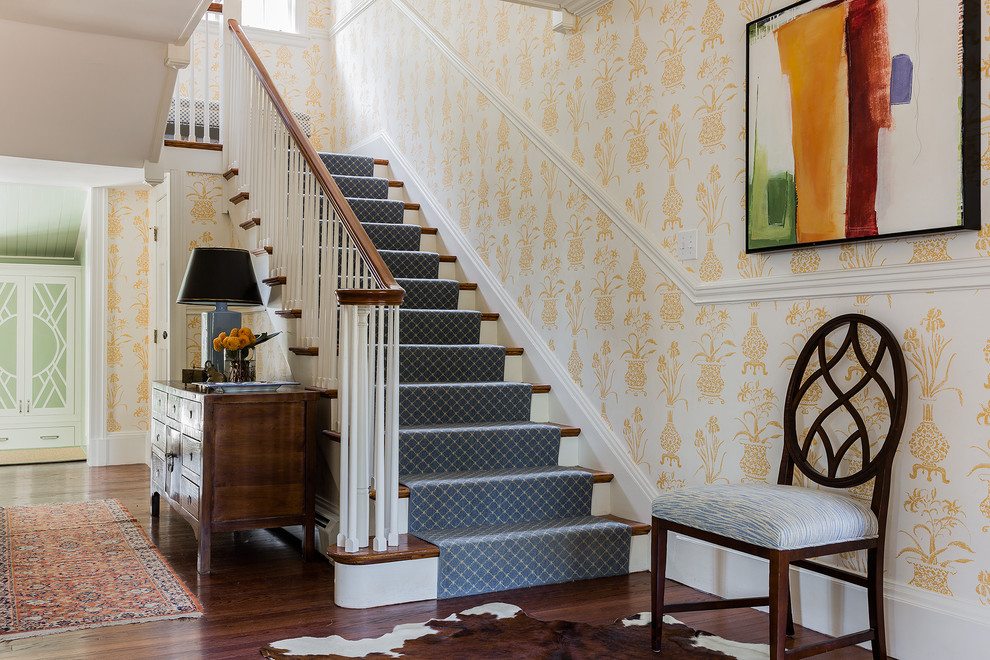 Traditional wood u-shaped staircase in Boston with painted wood risers.