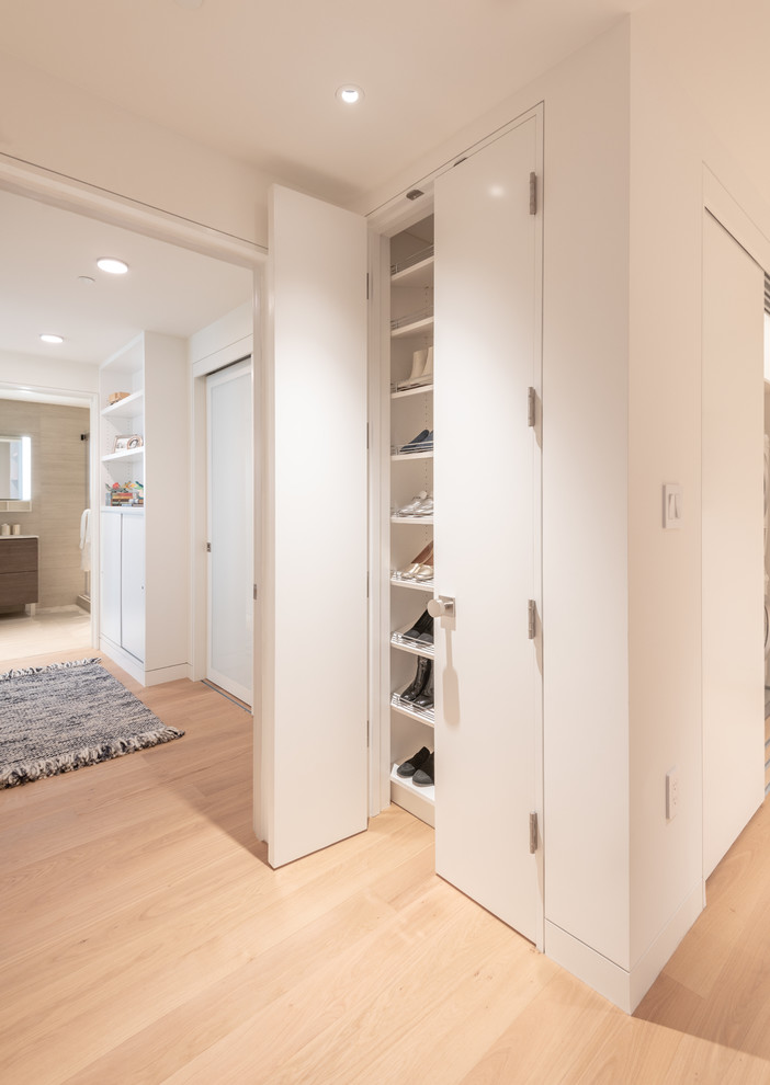 This is an example of a contemporary hallway in San Francisco with white walls and beige floor.