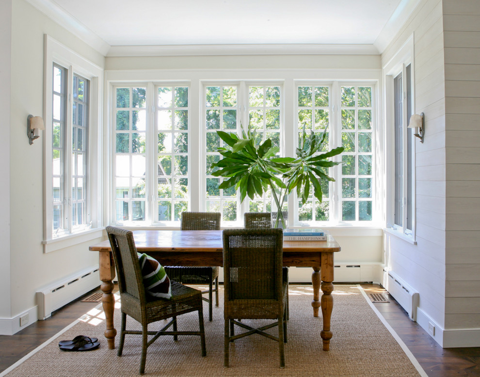 Inspiration for a traditional dining room in New York with white walls and dark hardwood floors.