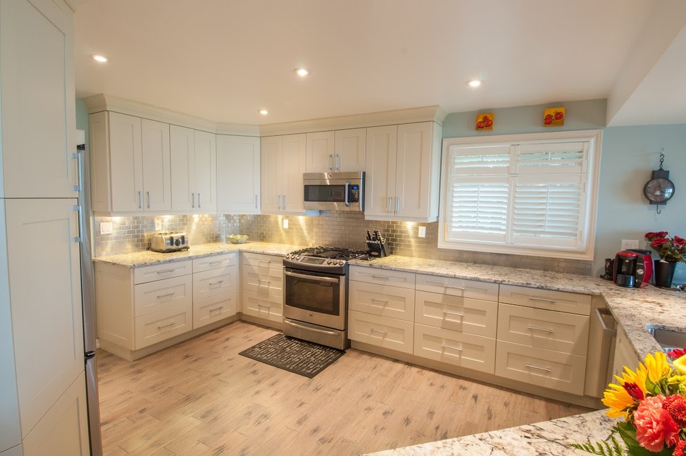Example of a transitional kitchen design in Toronto