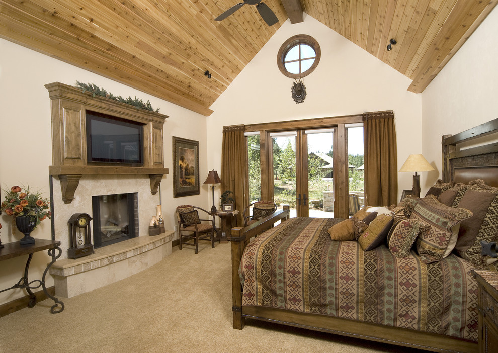 This is an example of a traditional bedroom in Other with beige walls, carpet and a standard fireplace.