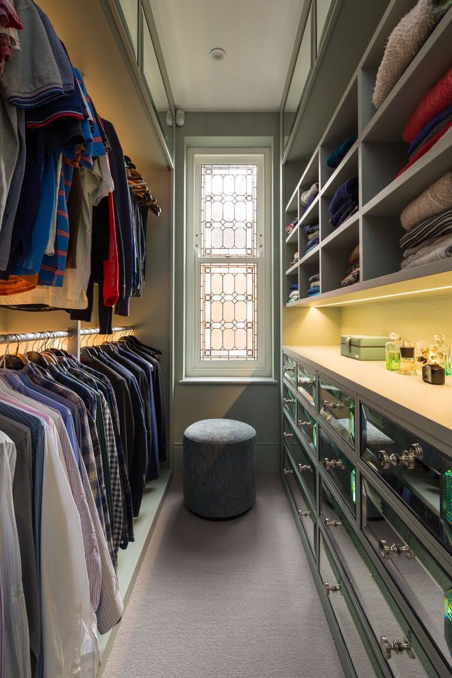 Inspiration for a traditional men's walk-in wardrobe in London with open cabinets, grey cabinets and grey floor.