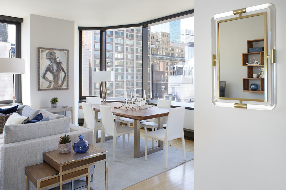 Inspiration for a transitional dining room in New York with grey walls and light hardwood floors.
