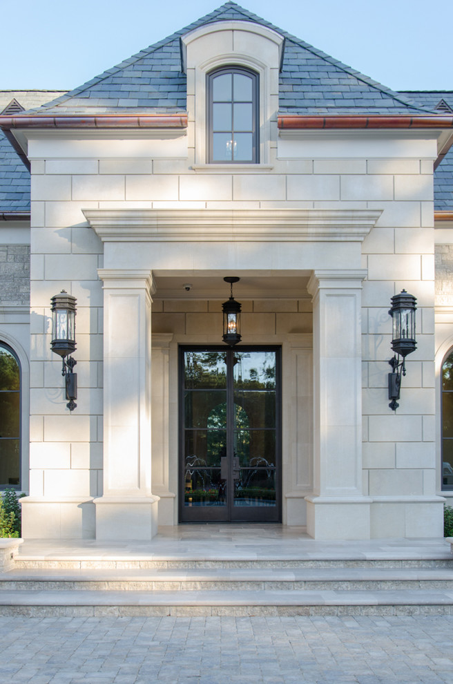 This is an example of an expansive mediterranean beige exterior in Houston with stone veneer and a gable roof.