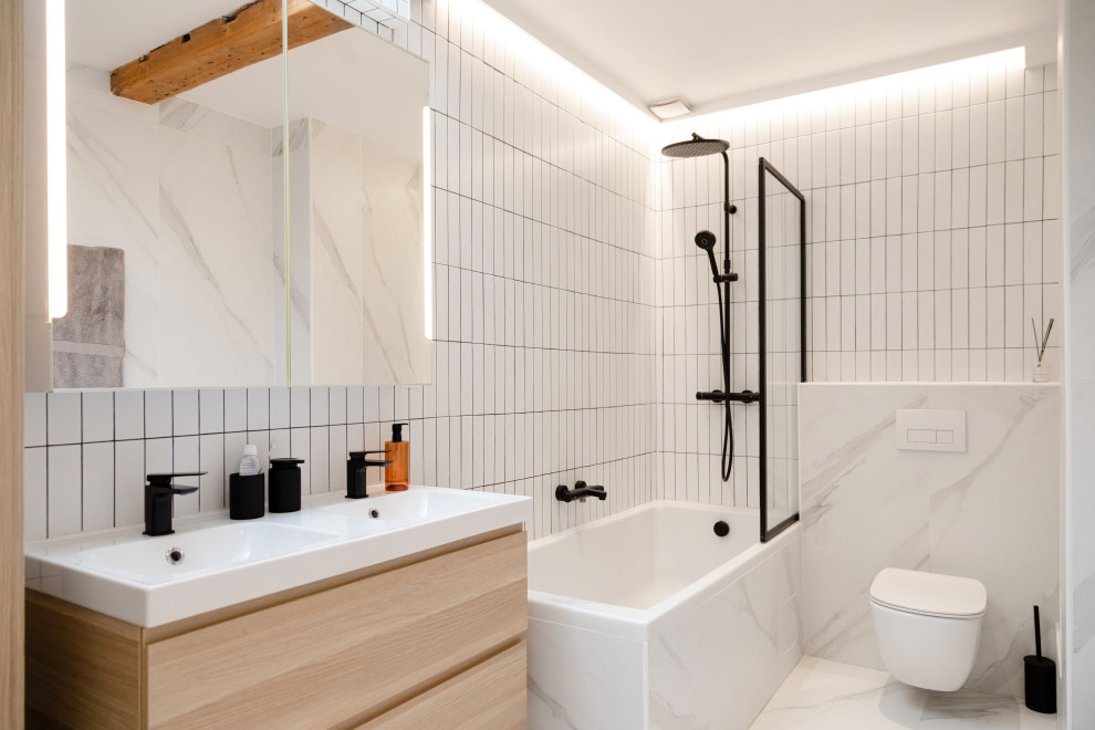 Industrial 3/4 bathroom in Paris with flat-panel cabinets, light wood cabinets, a corner tub, a shower/bathtub combo, a wall-mount toilet, white tile, a console sink, white floor, an open shower, white benchtops, a double vanity and a floating vanity.