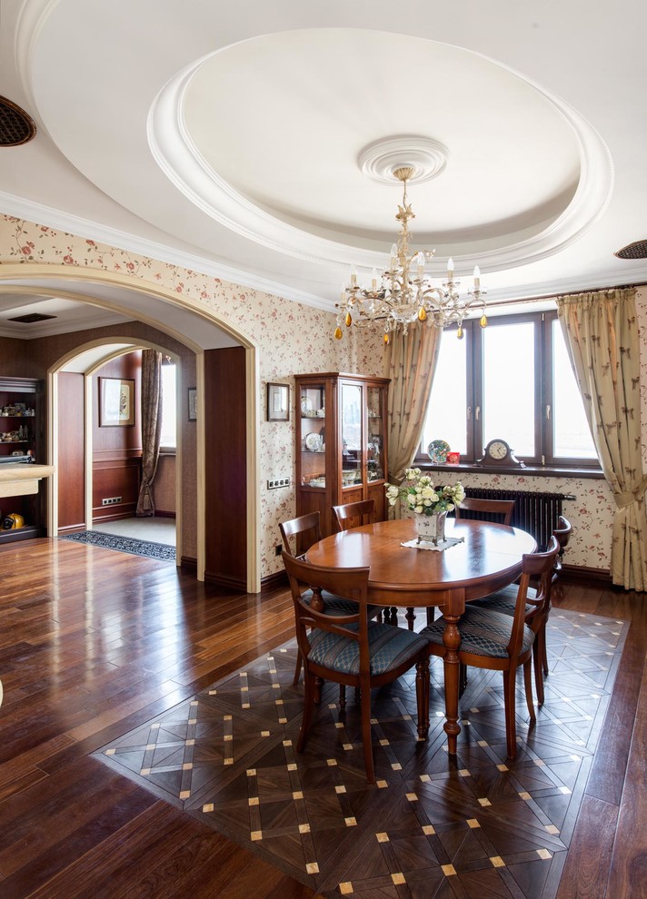 Photo of a medium sized traditional dining room in Moscow with beige walls, medium hardwood flooring, a standard fireplace and a stone fireplace surround.
