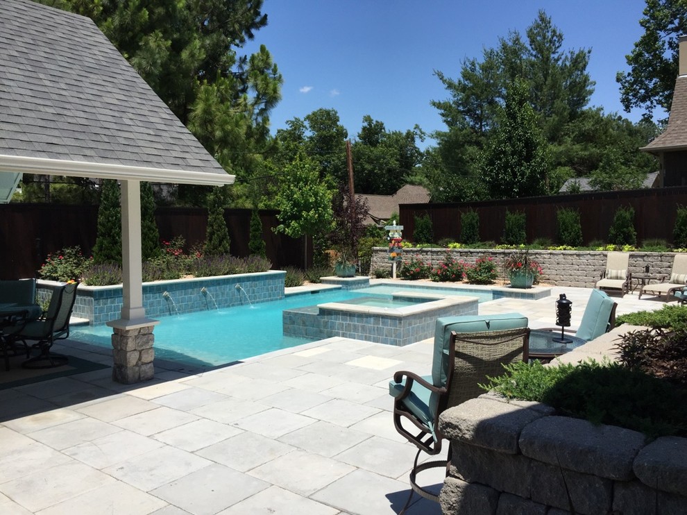 Large transitional backyard concrete paver and rectangular hot tub photo
