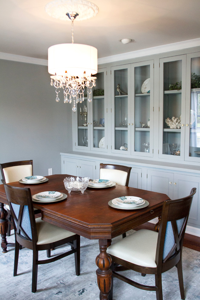 This is an example of a transitional dining room in Other with dark hardwood floors and grey walls.