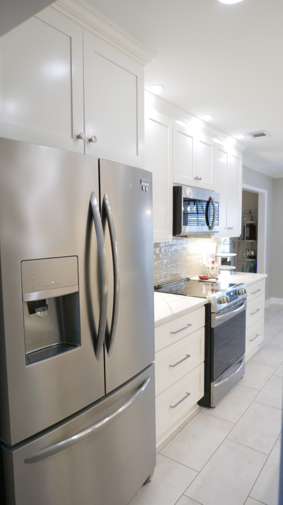 Mid-sized transitional galley porcelain tile and beige floor eat-in kitchen photo with an undermount sink, shaker cabinets, white cabinets, quartz countertops, brown backsplash, porcelain backsplash, stainless steel appliances, no island and white countertops