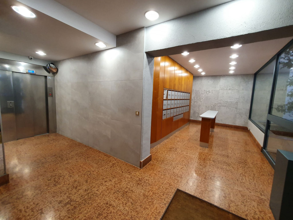 Exemple d'un hall d'entrée moderne de taille moyenne avec un mur gris, un sol en carrelage de céramique, une porte simple, un sol marron et un plafond décaissé.