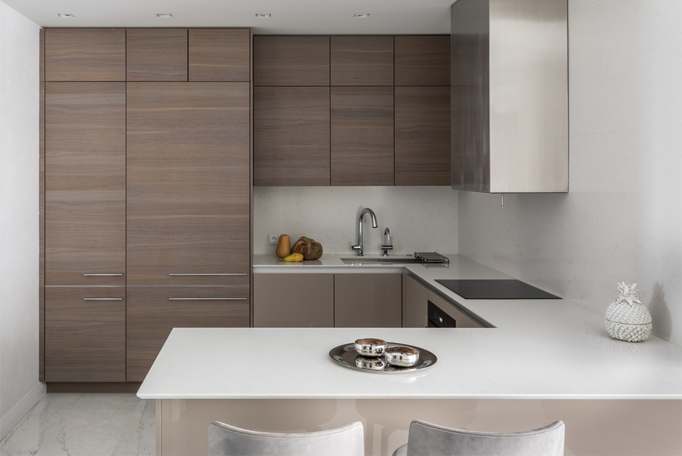 Contemporary u-shaped kitchen in Moscow with an undermount sink, flat-panel cabinets, medium wood cabinets, white splashback, a peninsula, white floor and white benchtop.