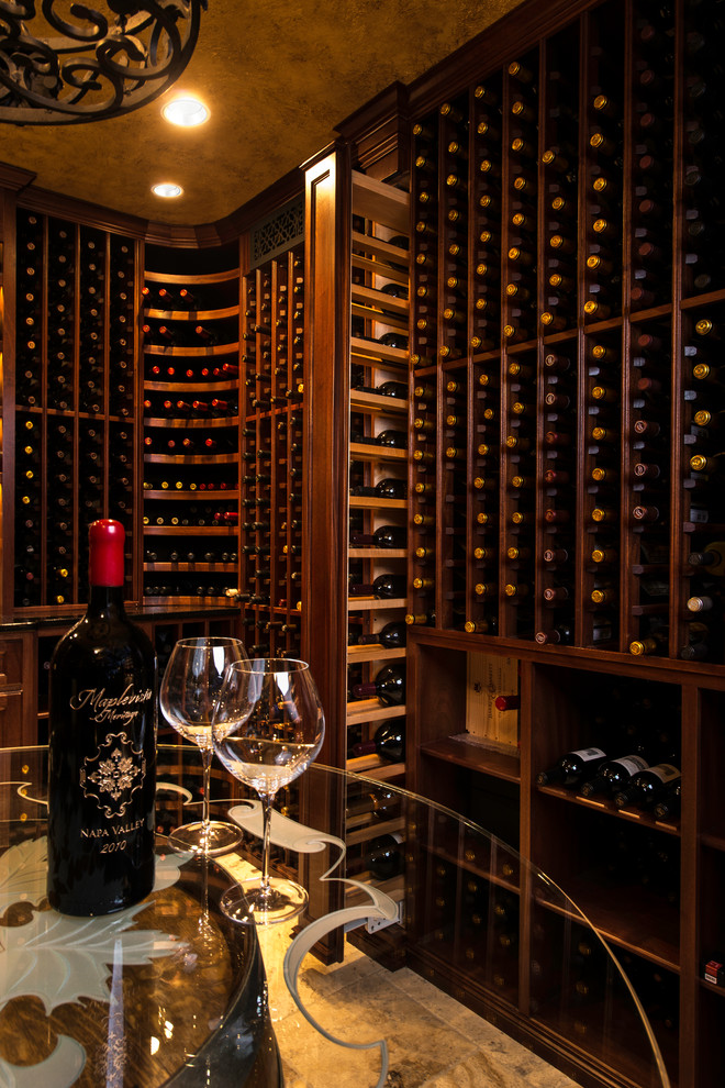 This is an example of a mid-sized traditional wine cellar in DC Metro with limestone floors, storage racks and beige floor.