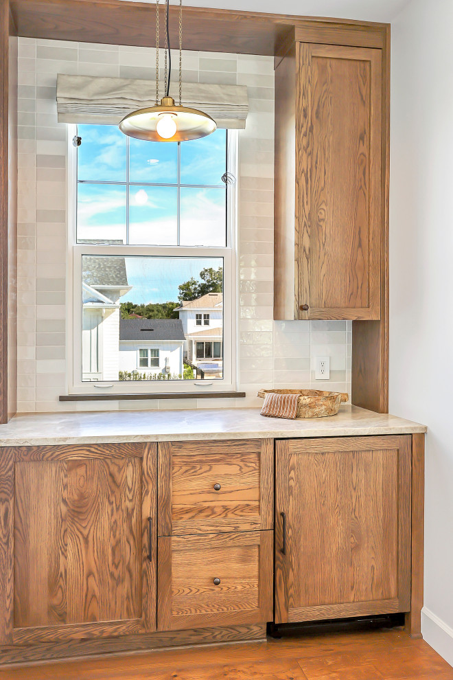 Example of a transitional home bar design in Orlando