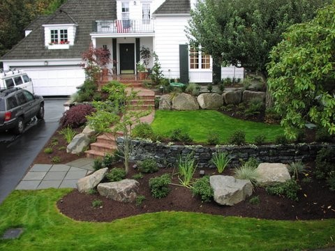 This is an example of a large traditional front yard full sun garden in Seattle with a garden path and brick pavers.