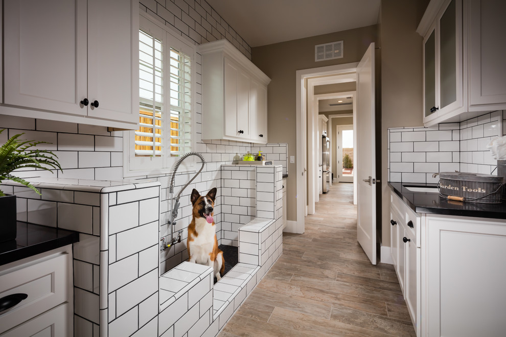 Example of a transitional utility room design in San Francisco with a side-by-side washer/dryer