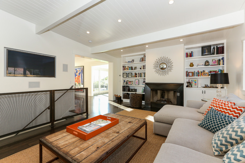 Contemporary open concept family room in San Francisco with white walls, dark hardwood floors, a standard fireplace, a stone fireplace surround and a wall-mounted tv.