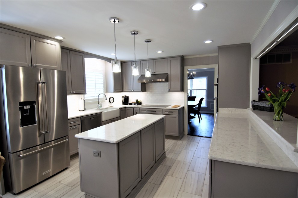 Eat-in kitchen - large transitional u-shaped porcelain tile and beige floor eat-in kitchen idea with a farmhouse sink, recessed-panel cabinets, gray cabinets, granite countertops, white backsplash, subway tile backsplash, stainless steel appliances, an island and beige countertops