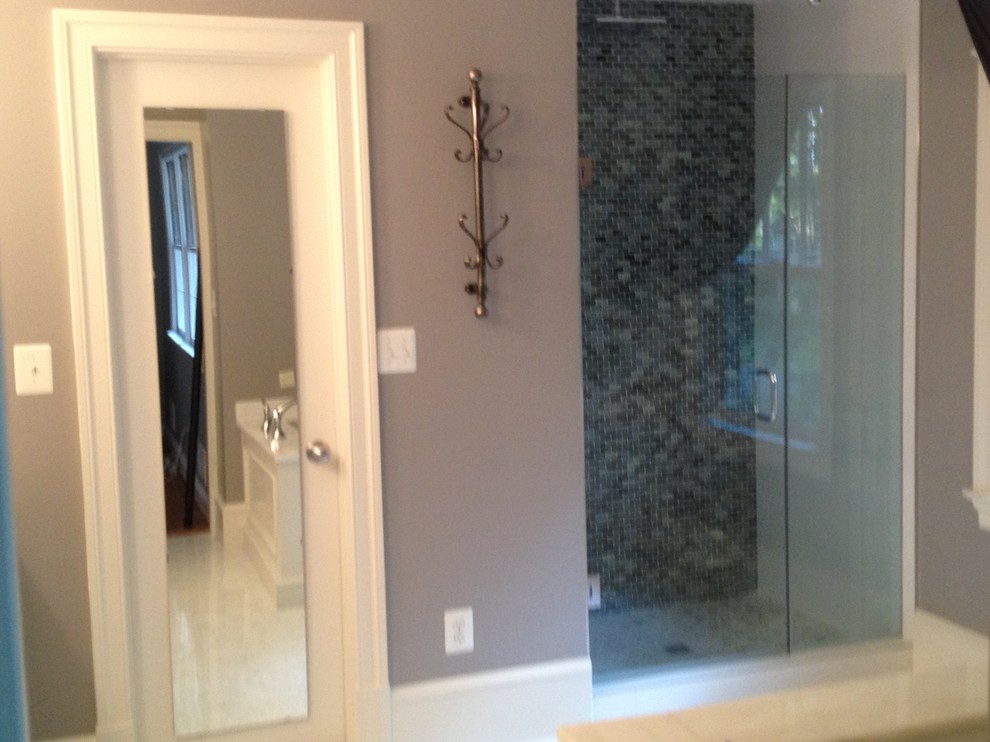 Example of a large transitional master multicolored tile and mosaic tile marble floor drop-in bathtub design in DC Metro with recessed-panel cabinets, white cabinets, a two-piece toilet, gray walls, an undermount sink and marble countertops