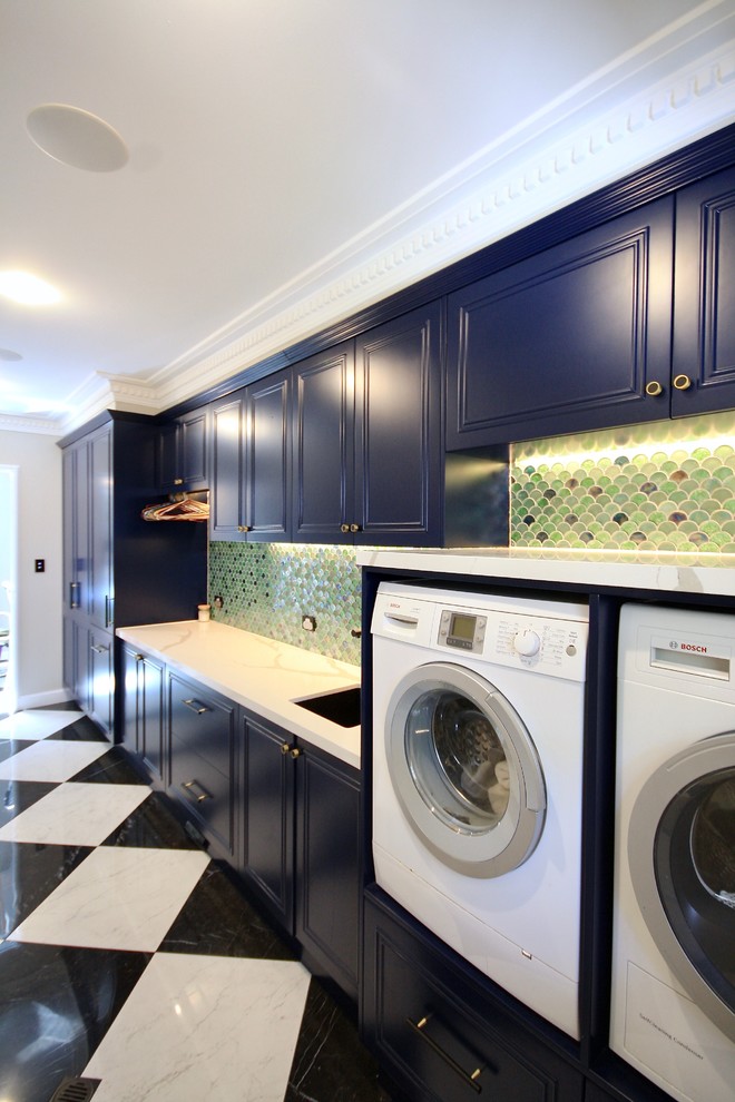 Inspiration for a large traditional galley dedicated laundry room in Sydney with an undermount sink, recessed-panel cabinets, blue cabinets, quartz benchtops, white walls, marble floors, a side-by-side washer and dryer, white floor and white benchtop.
