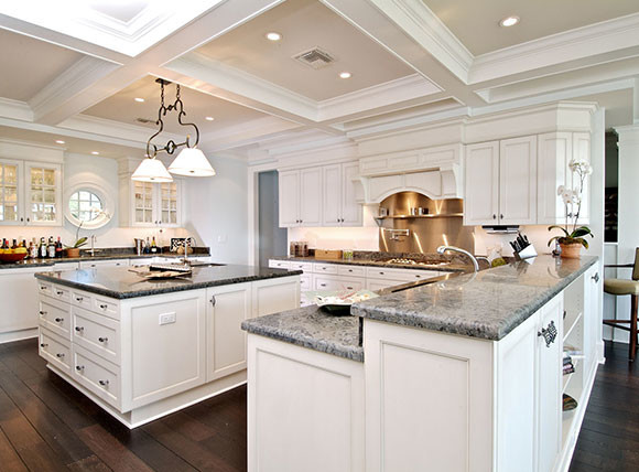 Eat-in kitchen - large transitional l-shaped dark wood floor and brown floor eat-in kitchen idea in Tampa with raised-panel cabinets, white cabinets, marble countertops, white backsplash, an island, an undermount sink, metal backsplash and stainless steel appliances
