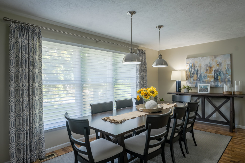 Transitional brown floor dining room photo in Grand Rapids with beige walls