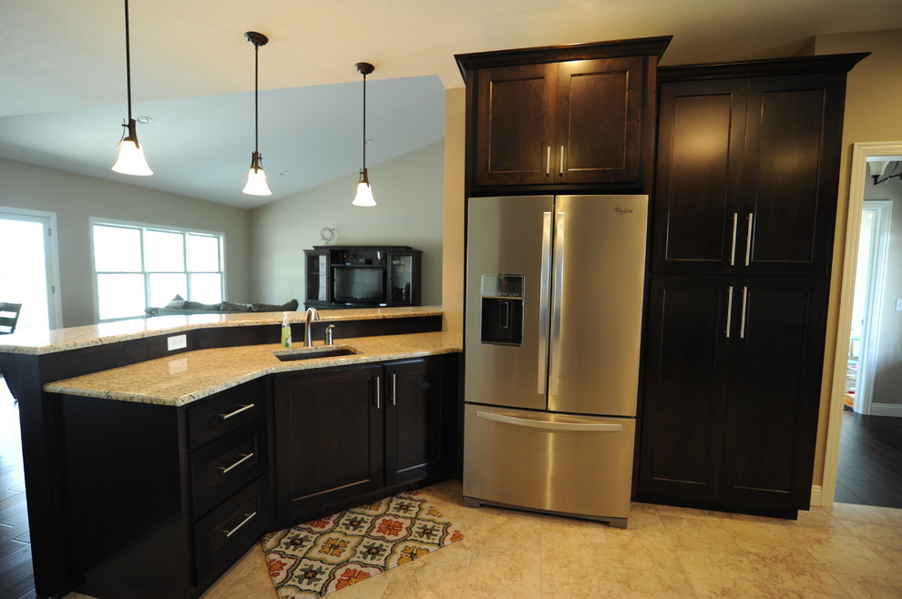 Eat-in kitchen - huge transitional u-shaped porcelain tile eat-in kitchen idea in Chicago with an undermount sink, shaker cabinets, dark wood cabinets, granite countertops, beige backsplash, ceramic backsplash, stainless steel appliances and a peninsula