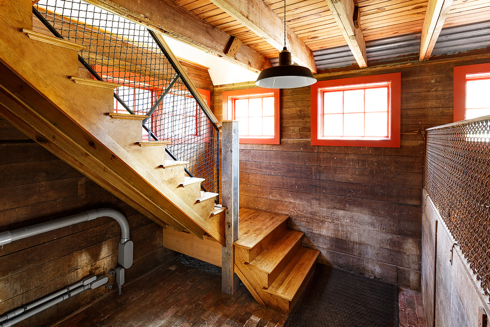 This is an example of a mid-sized country wood l-shaped staircase in Boston with wood risers and mixed railing.