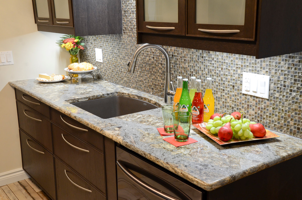 Inspiration for a mid-sized transitional galley porcelain tile kitchen remodel in Ottawa with an undermount sink, glass-front cabinets, brown cabinets, quartz countertops, brown backsplash, glass sheet backsplash and stainless steel appliances