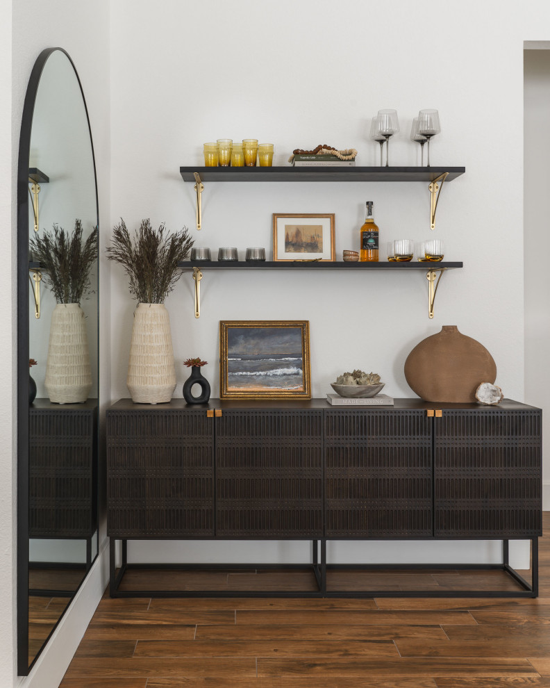Photo of a medium sized traditional l-shaped dry bar in Austin with dark wood cabinets, wood worktops, laminate floors, brown floors and brown worktops.