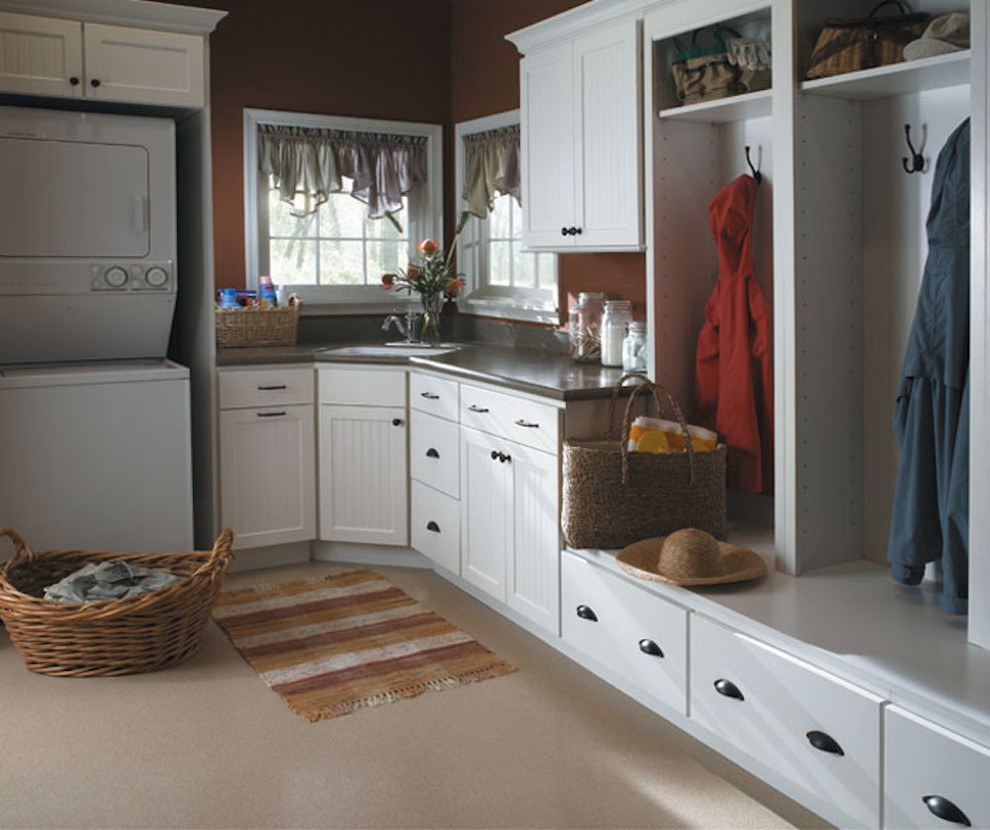 Design ideas for a large transitional l-shaped utility room in San Diego with an undermount sink, shaker cabinets, white cabinets, solid surface benchtops, brown walls, a side-by-side washer and dryer and beige floor.