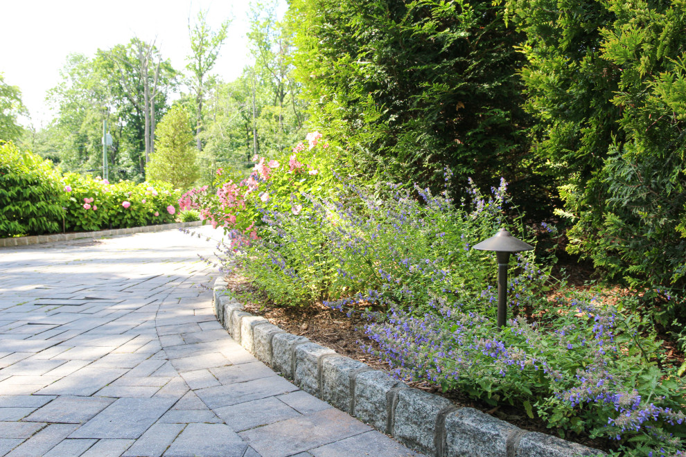 Photo of a front driveway partial sun garden in New York with a flowerbed.
