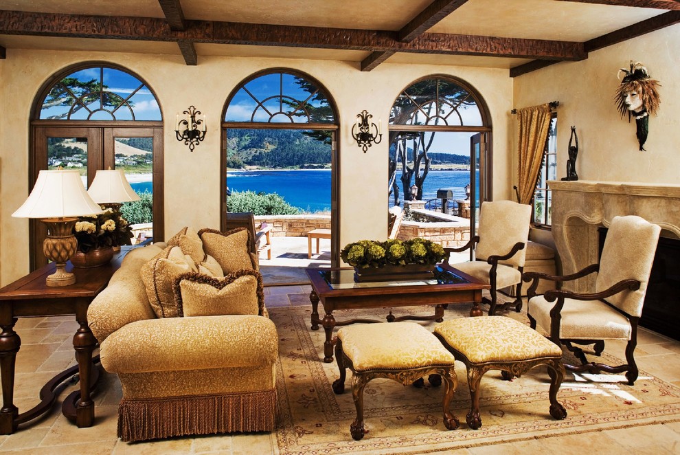 Inspiration for a mid-sized mediterranean formal open concept living room in Seattle with beige walls, a standard fireplace, a stone fireplace surround, no tv, beige floor and limestone floors.