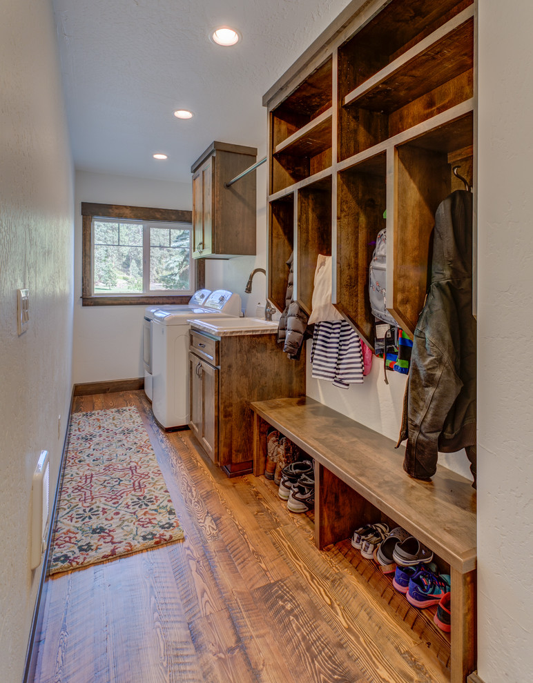 Inspiration for a small country single-wall utility room in Seattle with a drop-in sink, shaker cabinets, quartzite benchtops, white walls, medium hardwood floors, a side-by-side washer and dryer and dark wood cabinets.