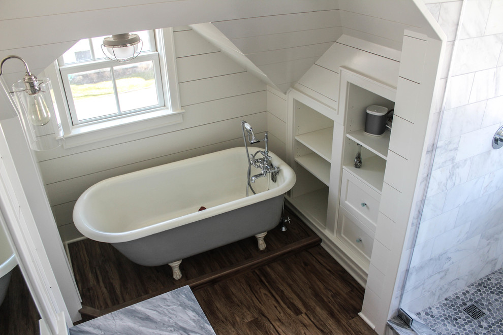 Design ideas for a small country master bathroom in New York with an integrated sink, furniture-like cabinets, white cabinets, marble benchtops, a claw-foot tub, an alcove shower, a one-piece toilet, gray tile, stone slab and white walls.