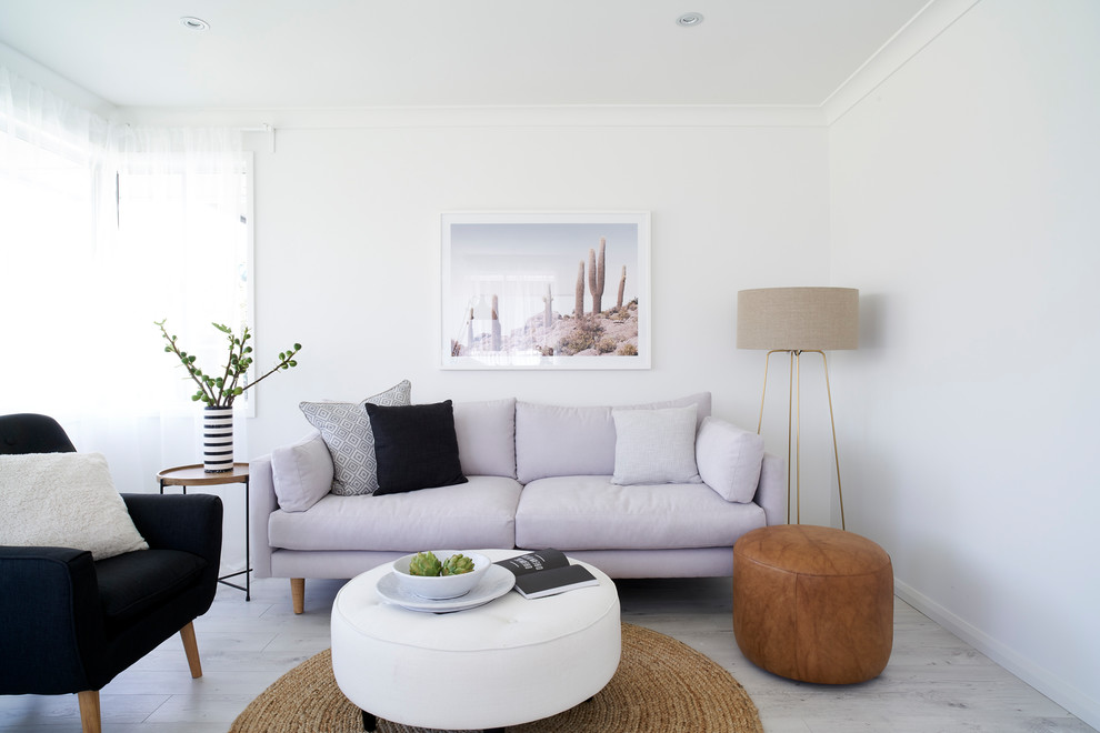 Photo of a mid-sized modern open concept living room in Sydney with white walls, light hardwood floors, no fireplace and grey floor.