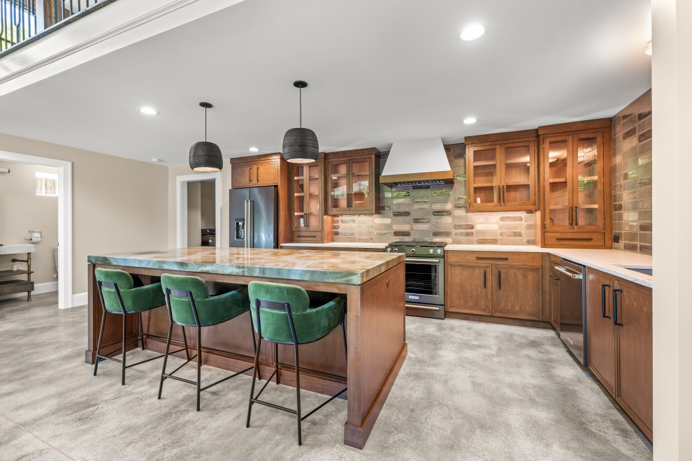 This is an example of a large modern open plan kitchen in Atlanta with a farmhouse sink, flat-panel cabinets, brown cabinets, quartzite benchtops, grey splashback, ceramic splashback, stainless steel appliances, concrete floors, with island, grey floor, blue benchtop and vaulted.
