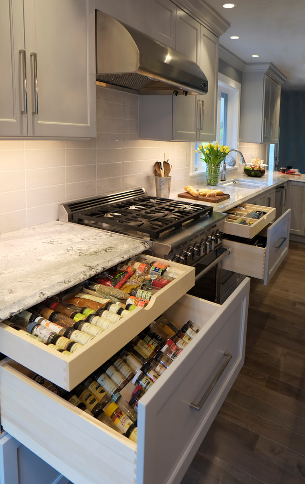 Inspiration for a large transitional eat-in kitchen in Seattle with an undermount sink, shaker cabinets, grey cabinets, quartz benchtops, white splashback, porcelain splashback, stainless steel appliances, medium hardwood floors and with island.