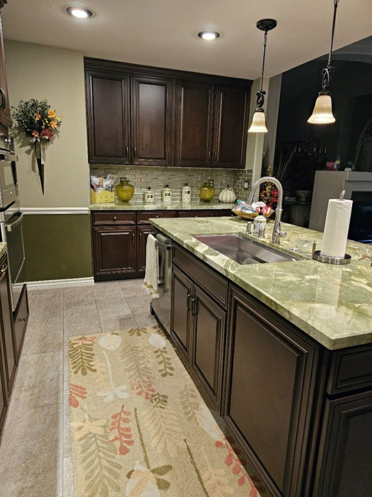 Kitchen - mid-sized transitional kitchen idea in Las Vegas with recessed-panel cabinets, brown cabinets and an island