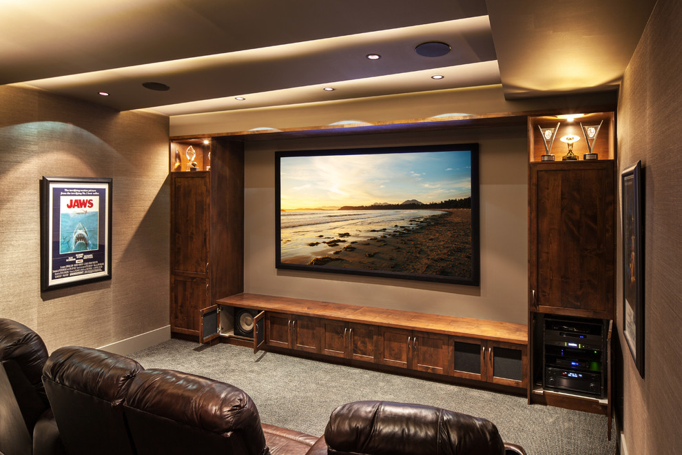Design ideas for a mid-sized transitional enclosed home theatre in Vancouver with carpet and a wall-mounted tv.