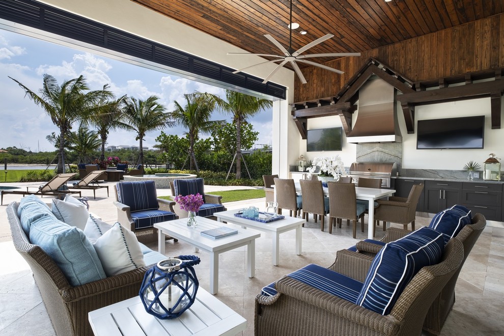 Design ideas for a beach style patio in Miami with an outdoor kitchen, tile and a roof extension.