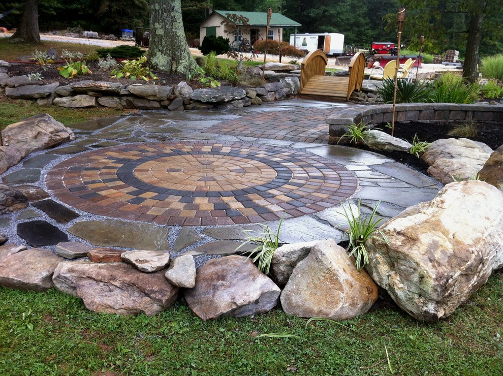 Mid-sized mountain style backyard stone patio photo in Baltimore with no cover